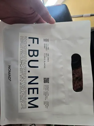 A bag of Nomad Burundi Niemba coffee beside the brewing dose shown on a scale.