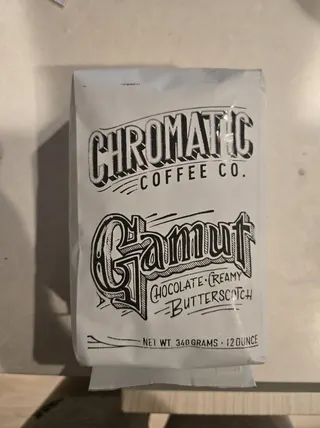 A white Chromatic Coffee Gamut bag photographed on a kitchen counter.